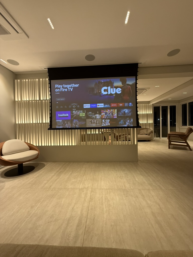 The cinema screen lowered, the lounge turned toward it.