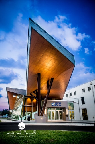 Copper eaves catching the last light over the community pavilion.