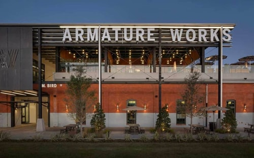 Armature Works at dusk — an old streetcar barn turned gathering place on the river.