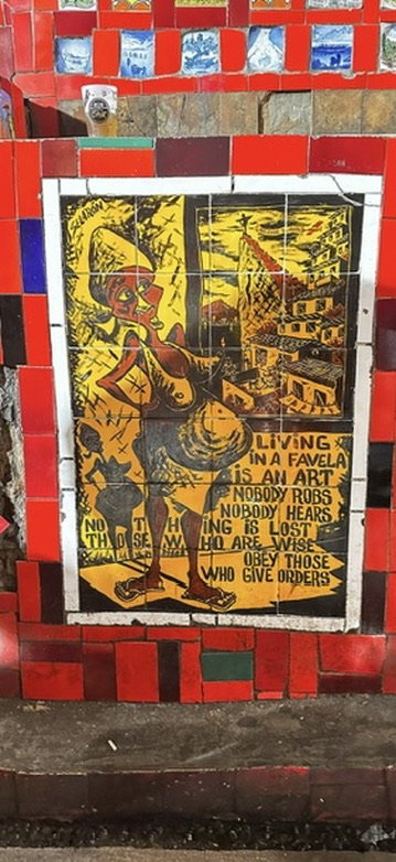 Tile artwork reading 'Living in a favela is an art'
