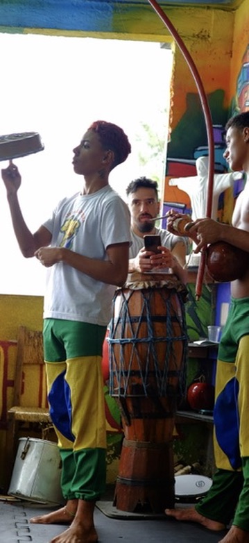 Musicians playing berimbau and drums during capoeira